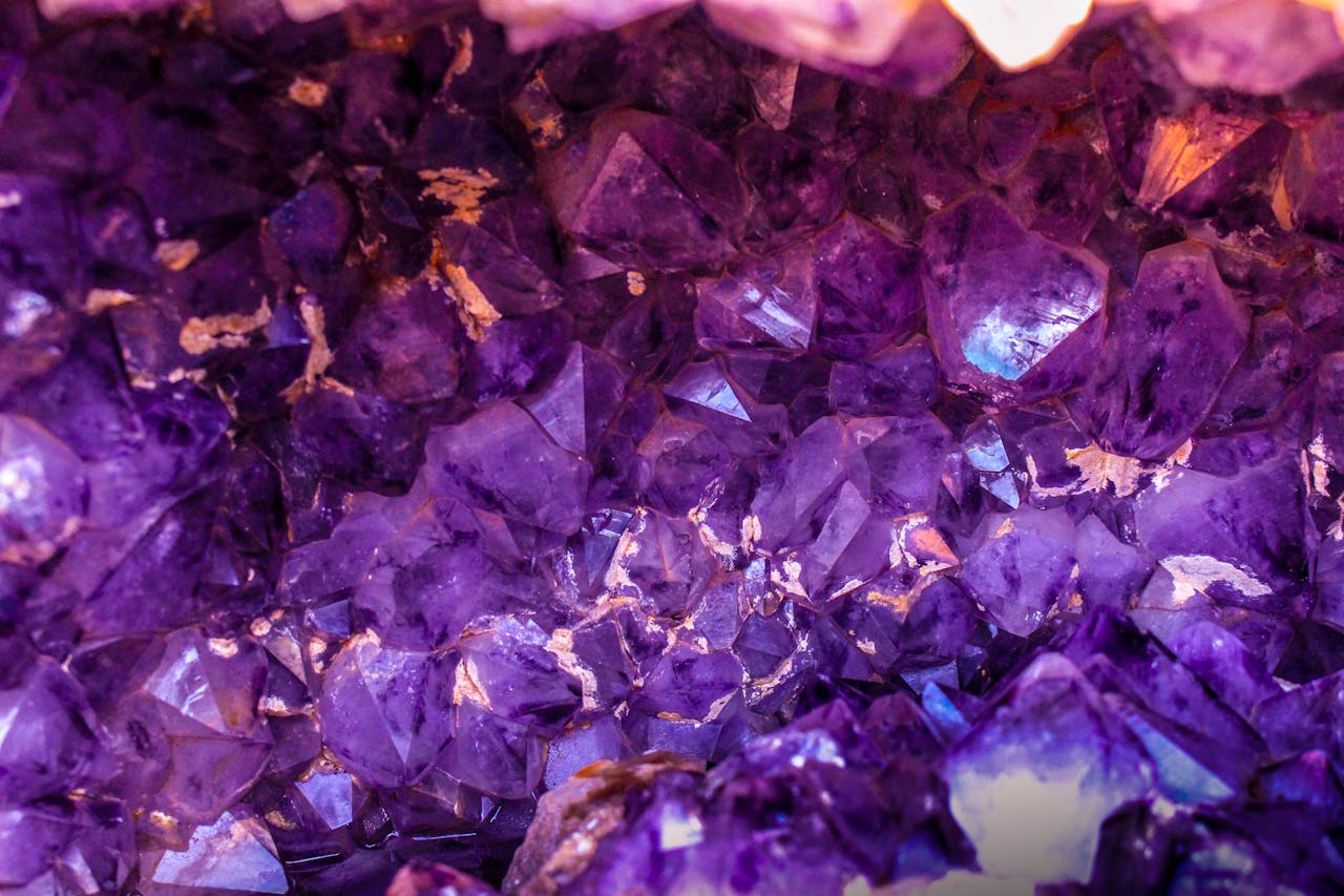 why-choose-us-01 Close-up view of a beautiful amethyst crystal cluster showcasing its vibrant purple hues and natural texture.